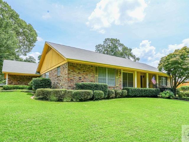 ranch-style home with brick siding and a front lawn