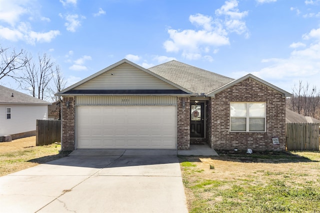 single story home with an attached garage, fence, brick siding, and driveway