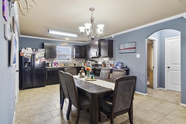 dining space featuring light tile patterned floors, baseboards, an inviting chandelier, arched walkways, and ornamental molding