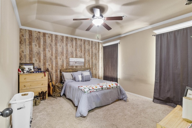 carpeted bedroom featuring crown molding and ceiling fan