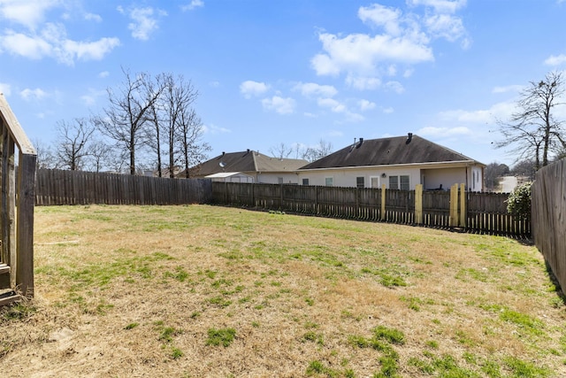 view of yard with a fenced backyard