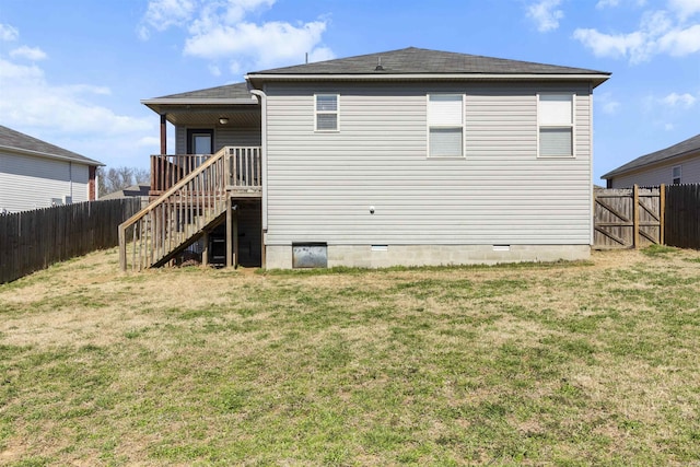 back of house with a yard, a shingled roof, stairs, and a fenced backyard