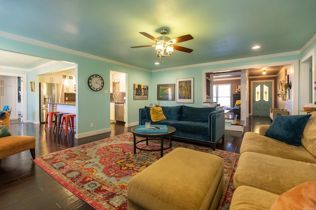 living area featuring ornamental molding, dark wood finished floors, recessed lighting, baseboards, and ceiling fan