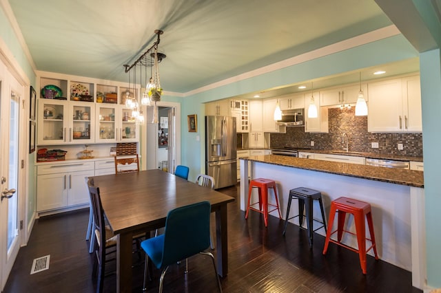 dining space with dark wood finished floors, recessed lighting, and visible vents