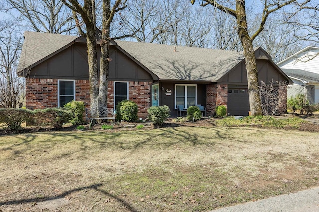 view of front facade featuring a front lawn, a garage, brick siding, and roof with shingles