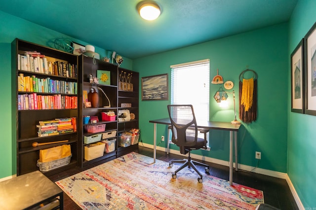 office area with baseboards and wood finished floors