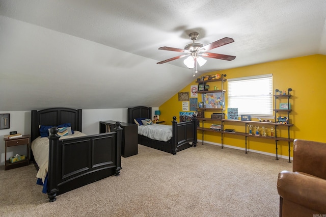 carpeted bedroom with a textured ceiling, a ceiling fan, baseboards, and vaulted ceiling