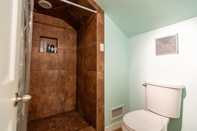 full bath with visible vents, lofted ceiling, toilet, and a shower stall