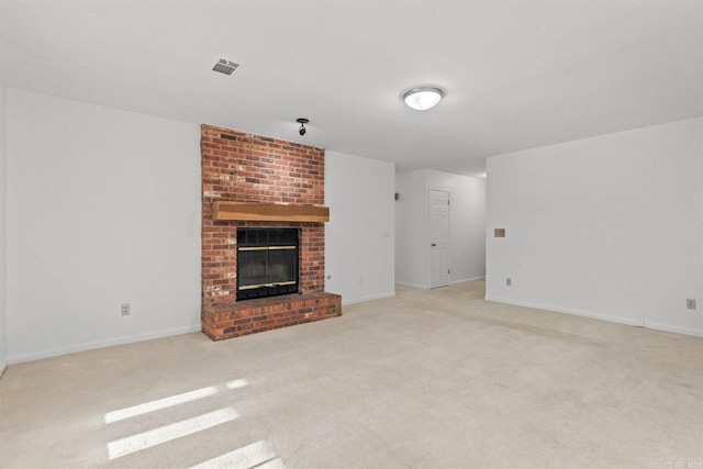 unfurnished living room with baseboards, visible vents, carpet floors, and a brick fireplace