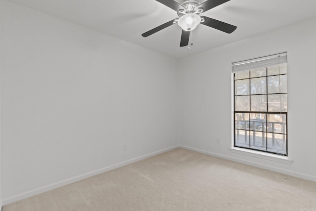 carpeted empty room with baseboards and ceiling fan