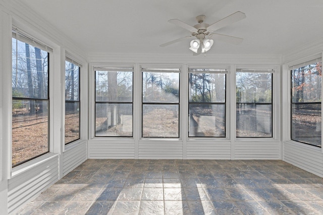 unfurnished sunroom with ceiling fan