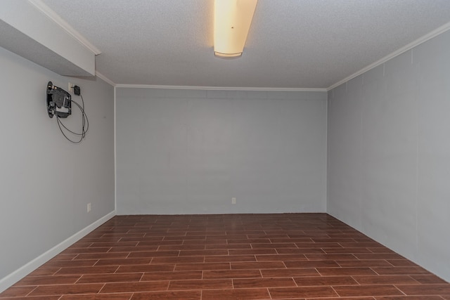 unfurnished room with a textured ceiling, crown molding, and wood finish floors