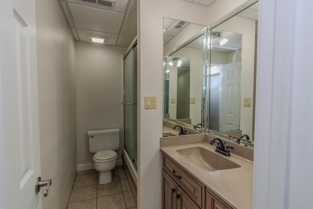 bathroom featuring vanity, visible vents, a shower with shower door, tile patterned floors, and toilet