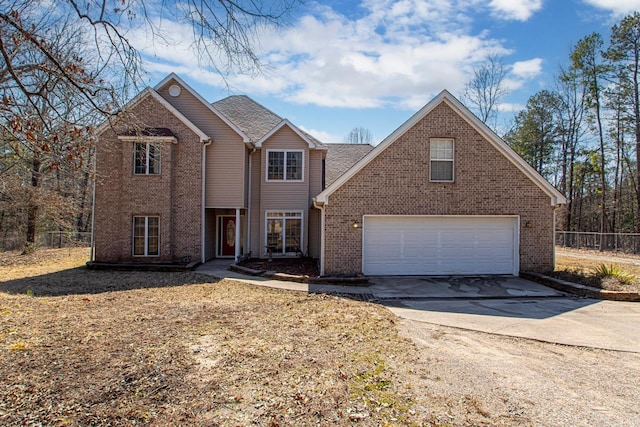 traditional home with brick siding, concrete driveway, fence, and a garage