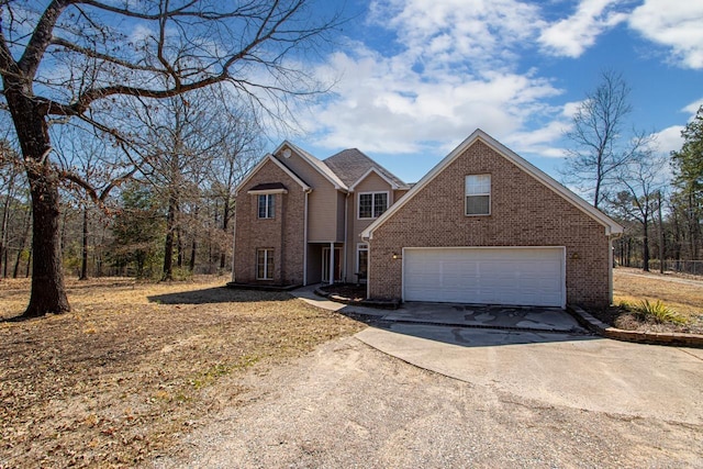 traditional home featuring an attached garage, brick siding, and driveway