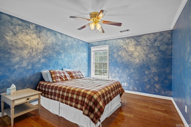 bedroom featuring visible vents, wallpapered walls, crown molding, baseboards, and wood finished floors