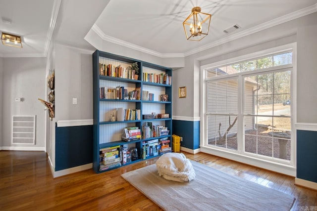 rec room with visible vents, hardwood / wood-style floors, and ornamental molding