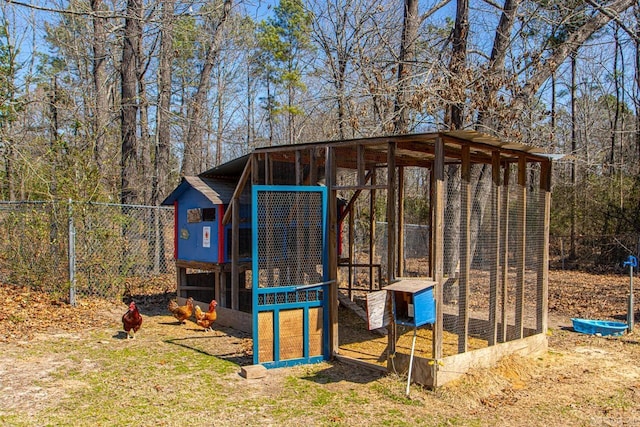 view of poultry coop featuring fence