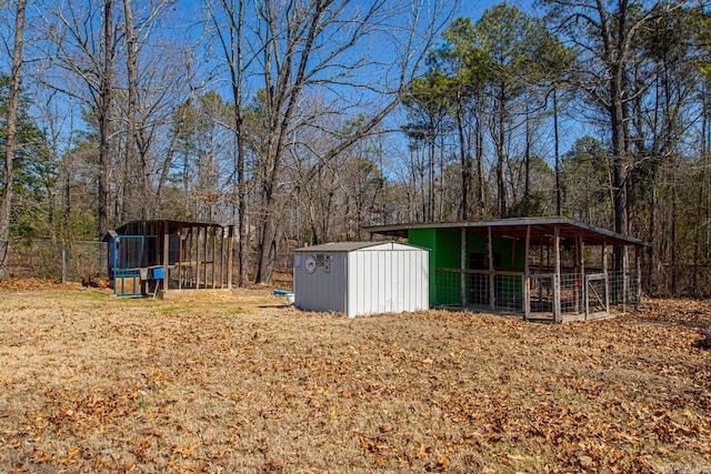 view of yard with an outbuilding, a shed, and a forest view