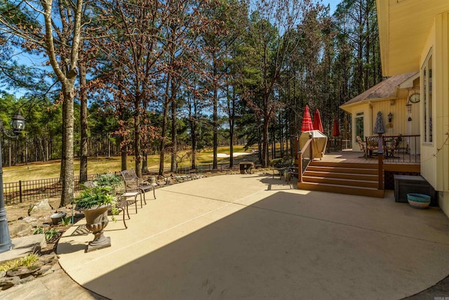 view of patio / terrace featuring a deck and fence