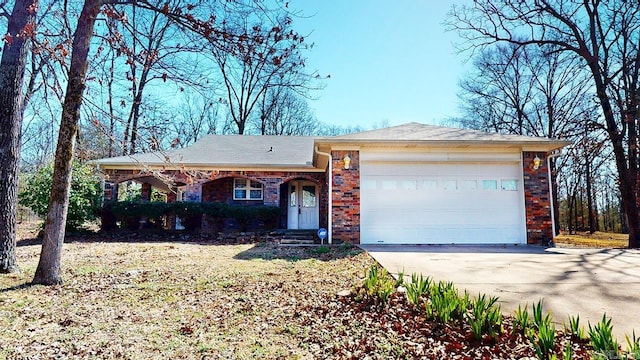 single story home with brick siding, concrete driveway, and an attached garage