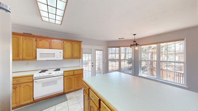 kitchen with light countertops, french doors, light tile patterned flooring, a notable chandelier, and white appliances