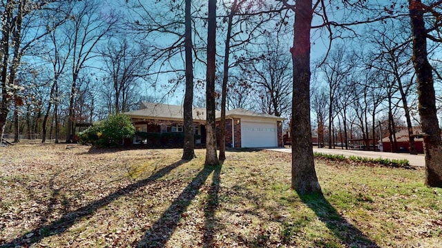 single story home featuring concrete driveway and a garage