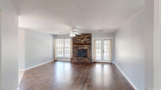 unfurnished living room with baseboards, dark wood-type flooring, ceiling fan, and a fireplace