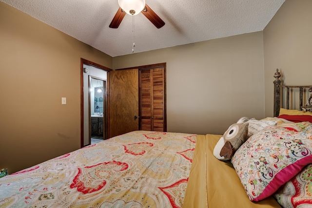 bedroom featuring a closet, a textured ceiling, and a ceiling fan