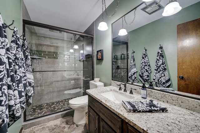 full bathroom with visible vents, a shower stall, toilet, and vanity