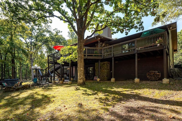 back of house with stairway, a chimney, and a deck