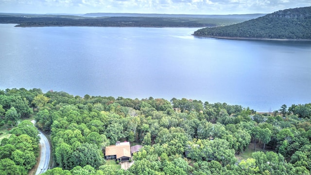 aerial view with a wooded view and a water view