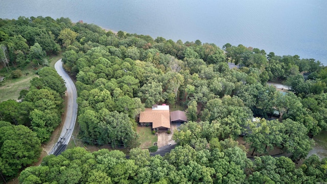 drone / aerial view featuring a wooded view