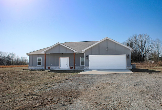 view of front facade featuring a garage, board and batten siding, and driveway