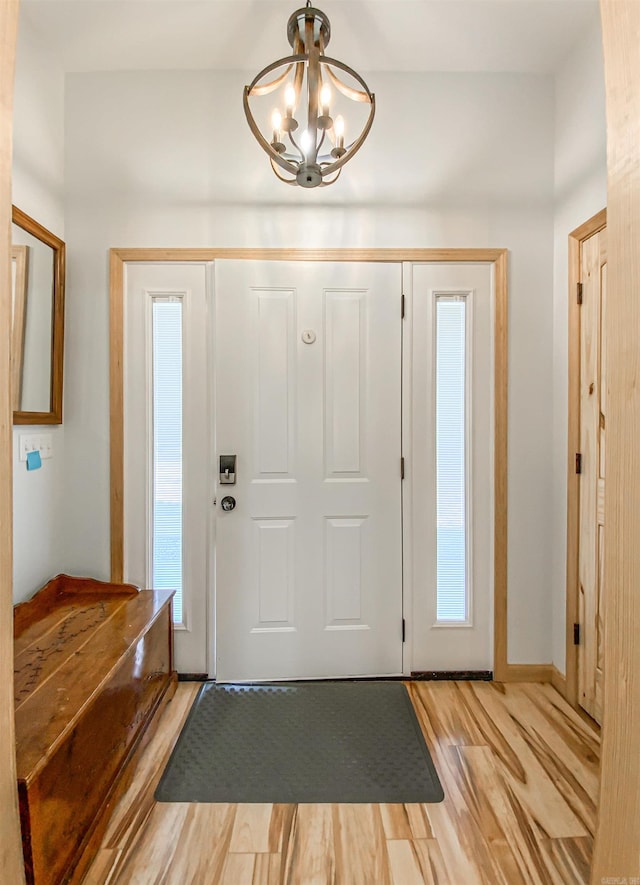 entrance foyer featuring a notable chandelier and light wood-style floors