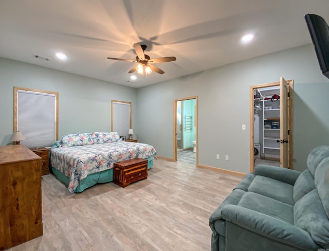 bedroom with light wood finished floors, visible vents, a spacious closet, baseboards, and recessed lighting