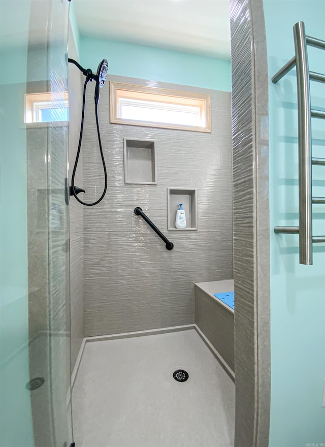 bathroom featuring a healthy amount of sunlight and a stall shower