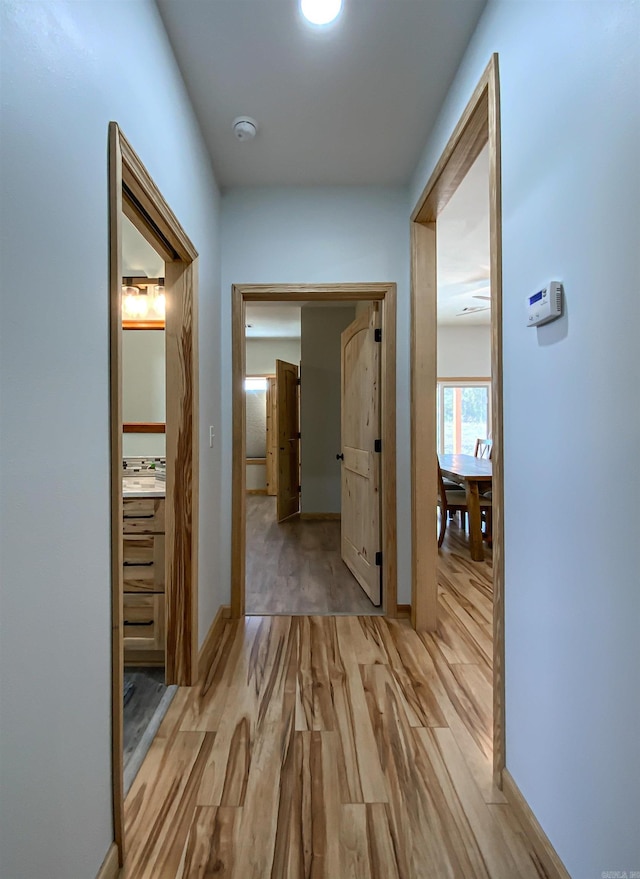 corridor featuring light wood-style flooring