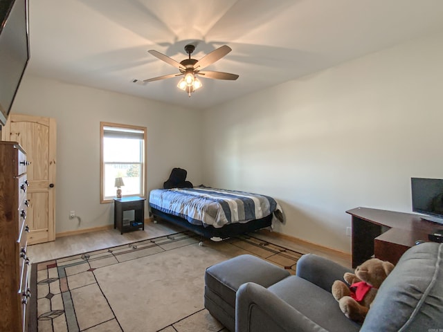 bedroom with baseboards and a ceiling fan