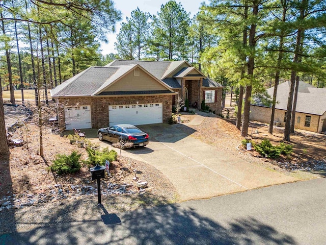 view of front of property with concrete driveway, an attached garage, and a shingled roof