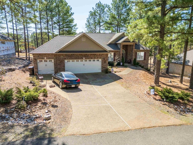 view of front facade featuring driveway, roof with shingles, and an attached garage