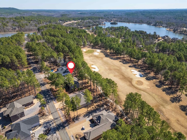 birds eye view of property with a forest view and a water view