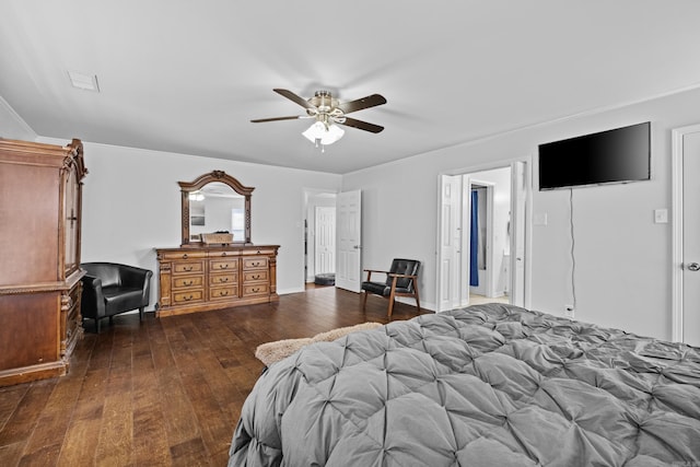 bedroom featuring a ceiling fan, visible vents, and dark wood-style flooring