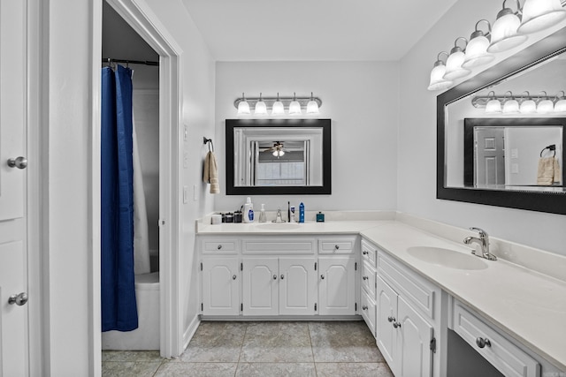 bathroom featuring double vanity, tile patterned flooring, a shower with curtain, and a sink