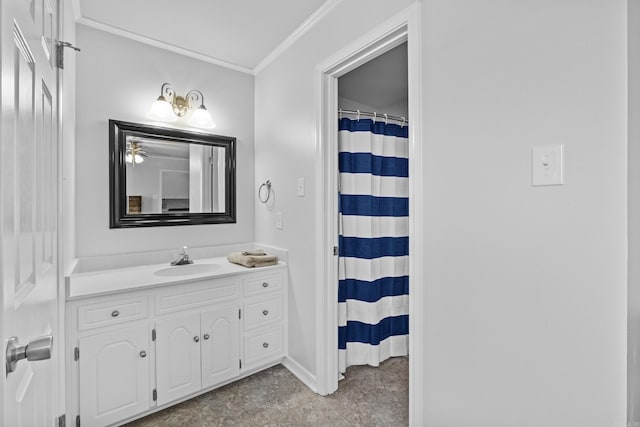 bathroom with curtained shower, vanity, baseboards, and ornamental molding