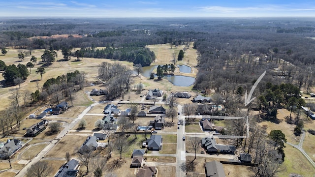 bird's eye view with a view of trees and a water view