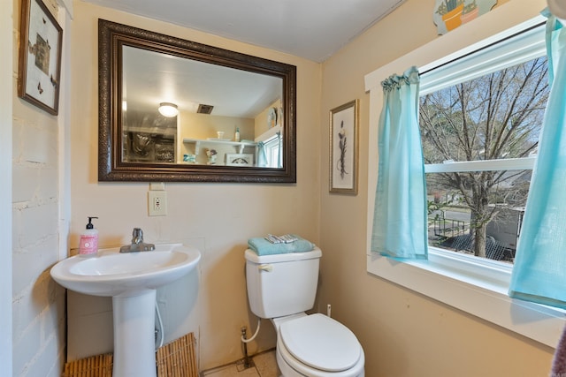 half bath with a sink and toilet