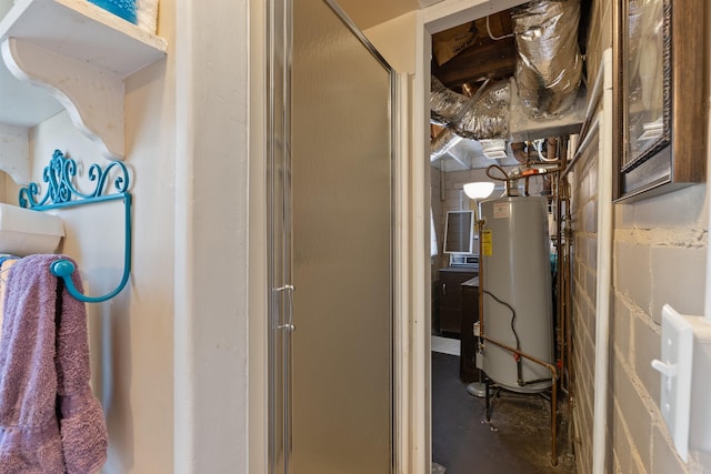 bathroom featuring gas water heater, concrete block wall, a stall shower, and concrete floors