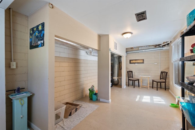 interior space featuring visible vents and concrete block wall