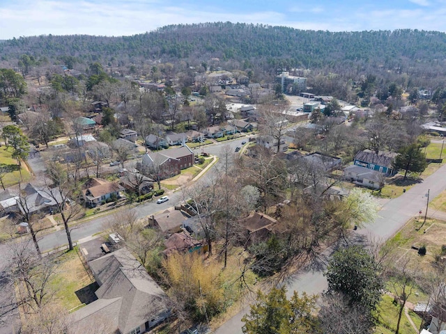 drone / aerial view with a residential view and a wooded view